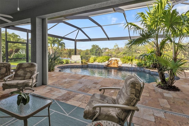 view of swimming pool featuring a lanai, pool water feature, and a patio area