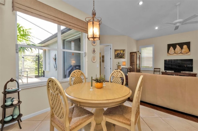 tiled dining space featuring a wealth of natural light and ceiling fan