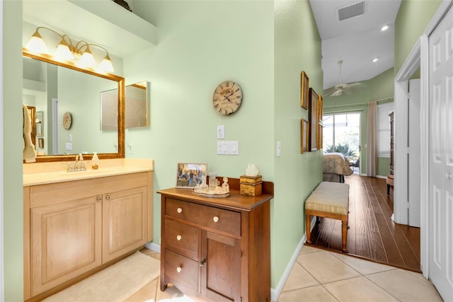 bathroom with wood-type flooring, vanity, and ceiling fan