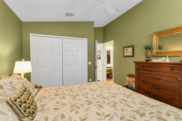 bedroom featuring lofted ceiling, ceiling fan, and a closet