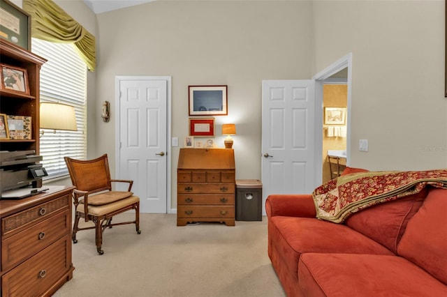 living area with light colored carpet and lofted ceiling