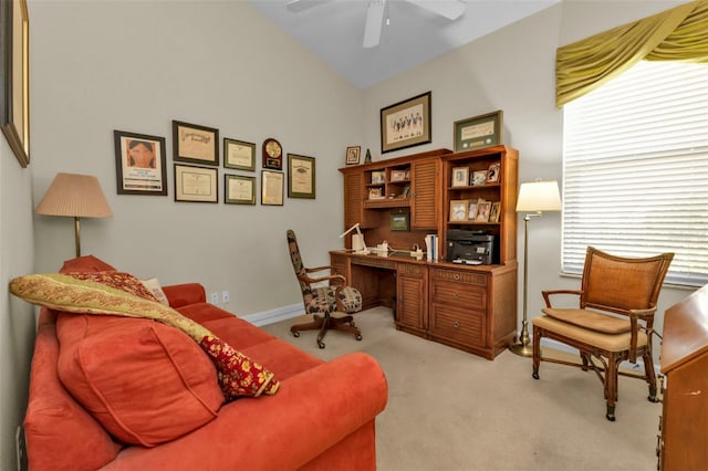 home office featuring light carpet, lofted ceiling, and ceiling fan