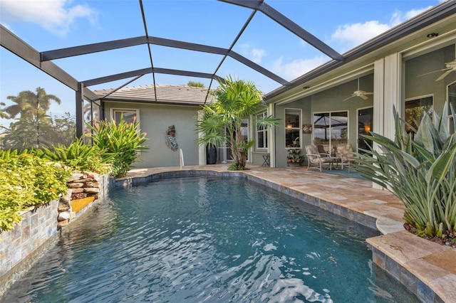 view of pool featuring a lanai, a patio, and ceiling fan