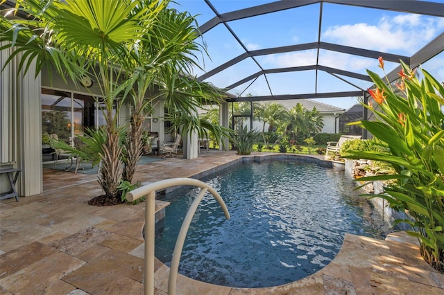 view of swimming pool featuring a lanai and a patio area