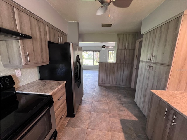 kitchen featuring black range with electric stovetop, stainless steel refrigerator with ice dispenser, decorative backsplash, ceiling fan, and light tile patterned flooring