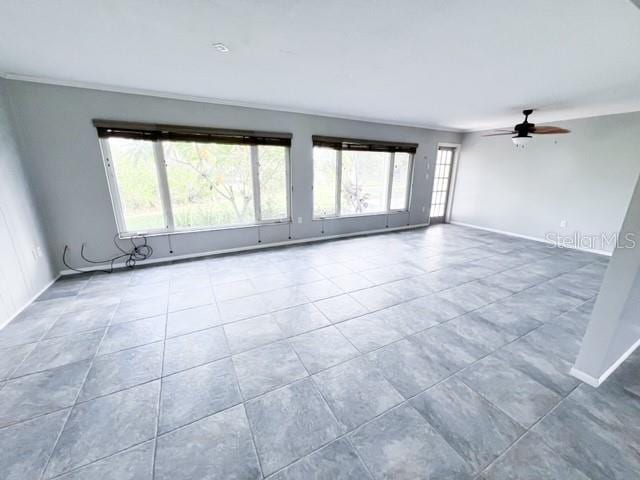 tiled spare room with ceiling fan