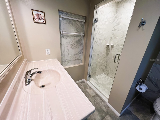 bathroom featuring toilet, vanity, and walk in shower