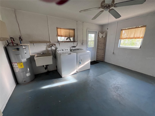 washroom featuring ceiling fan, electric water heater, washing machine and dryer, and sink