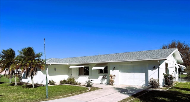 ranch-style house with a front yard and a garage