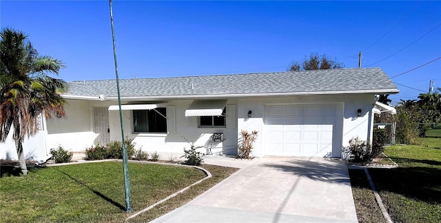 ranch-style home with a front lawn and a garage