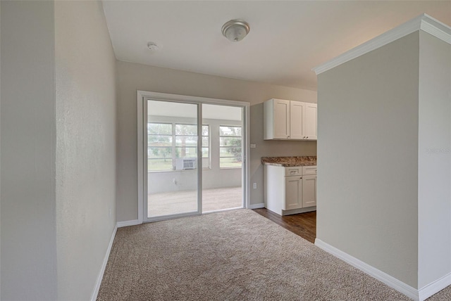 unfurnished room with dark colored carpet