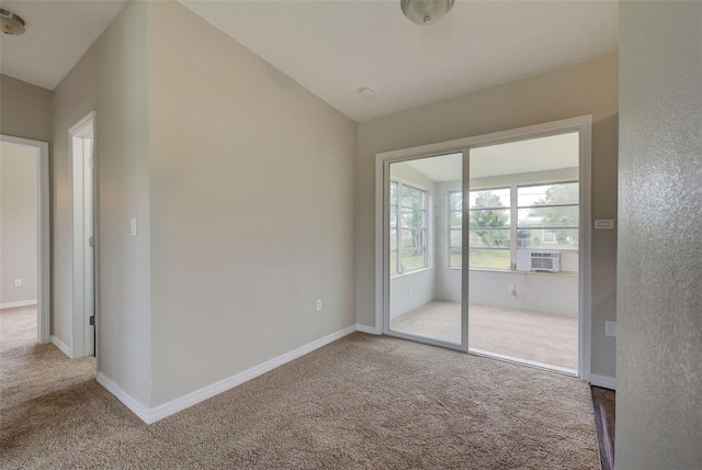 empty room with cooling unit, carpet, and vaulted ceiling