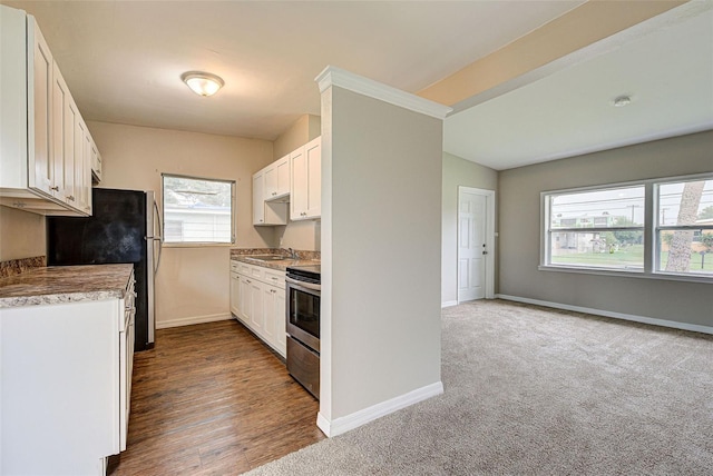 kitchen featuring sink, white cabinetry, fridge, stainless steel range with electric cooktop, and dark hardwood / wood-style flooring