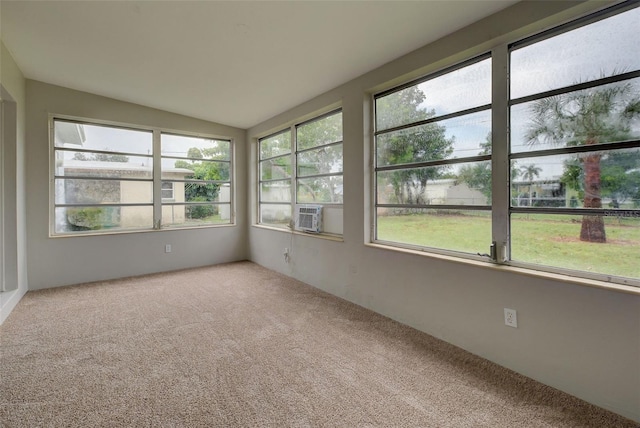 unfurnished sunroom with a wealth of natural light, lofted ceiling, and cooling unit