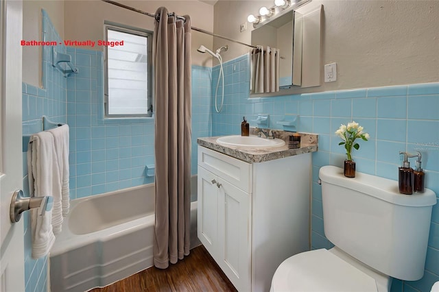 full bathroom featuring tile walls, shower / bathtub combination with curtain, vanity, hardwood / wood-style flooring, and toilet