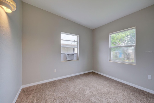 carpeted spare room with cooling unit and lofted ceiling