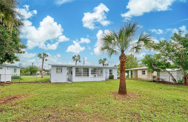 back of house with a lawn