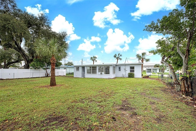 back of house featuring a yard