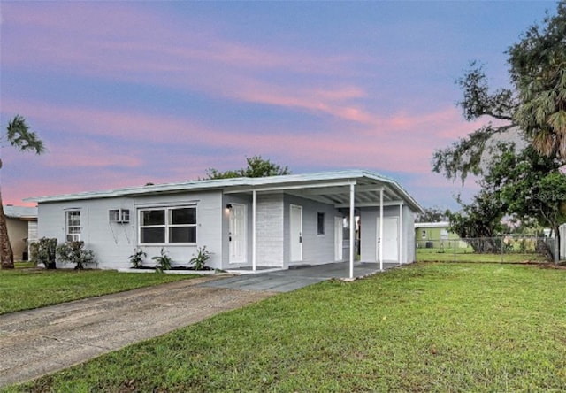 view of front of house with a lawn and a carport