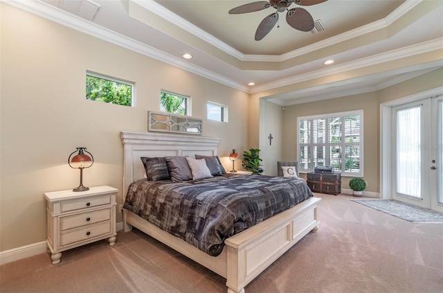 carpeted bedroom featuring multiple windows, ceiling fan, a raised ceiling, and crown molding