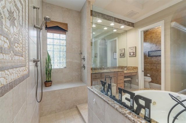 bathroom featuring toilet, tile patterned floors, tiled shower, vanity, and crown molding