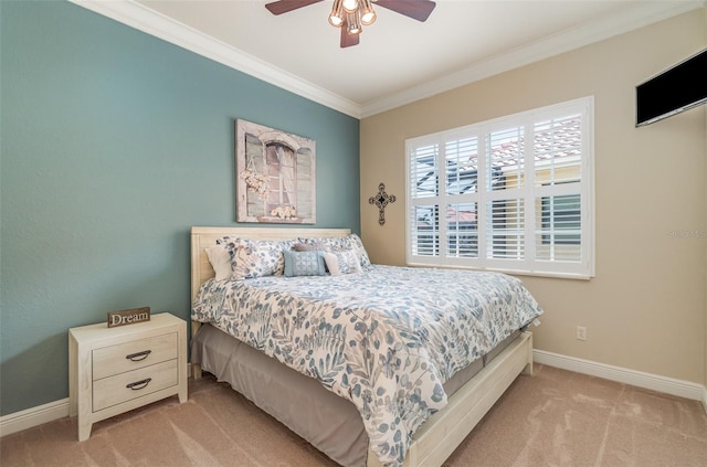 bedroom featuring ceiling fan, light carpet, and ornamental molding