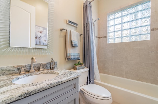 full bathroom with vanity, shower / tub combo with curtain, and toilet