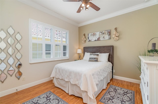 bedroom with light hardwood / wood-style floors, crown molding, and ceiling fan