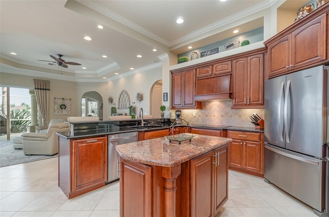 kitchen featuring a kitchen island, custom range hood, kitchen peninsula, stainless steel appliances, and sink