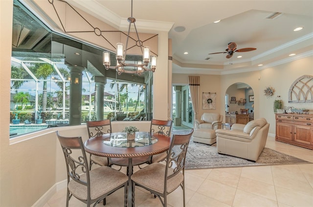 dining room featuring crown molding, a healthy amount of sunlight, and light tile patterned floors