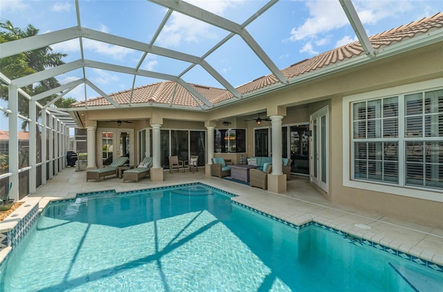 view of swimming pool featuring a patio, an outdoor living space, a lanai, and ceiling fan