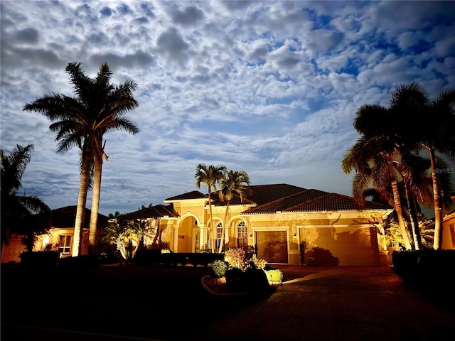 mediterranean / spanish home with a garage