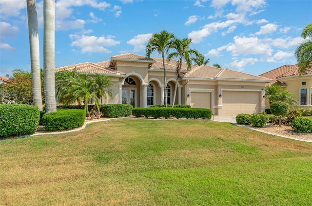 mediterranean / spanish-style home with a front lawn and a garage