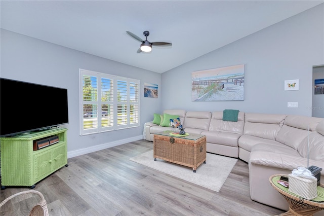 living room featuring light wood-type flooring, vaulted ceiling, and ceiling fan