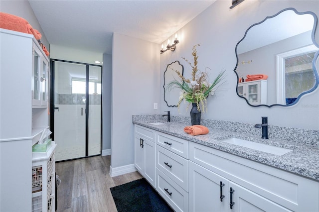 bathroom featuring vanity, hardwood / wood-style floors, and an enclosed shower