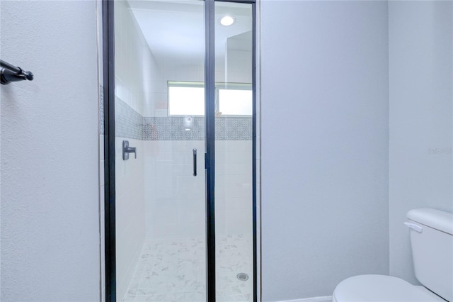 bathroom with toilet and an enclosed shower