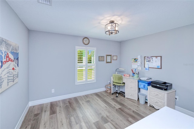 office area featuring light hardwood / wood-style flooring and a notable chandelier