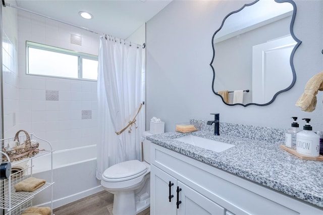 full bathroom with wood-type flooring, vanity, toilet, and shower / tub combo with curtain