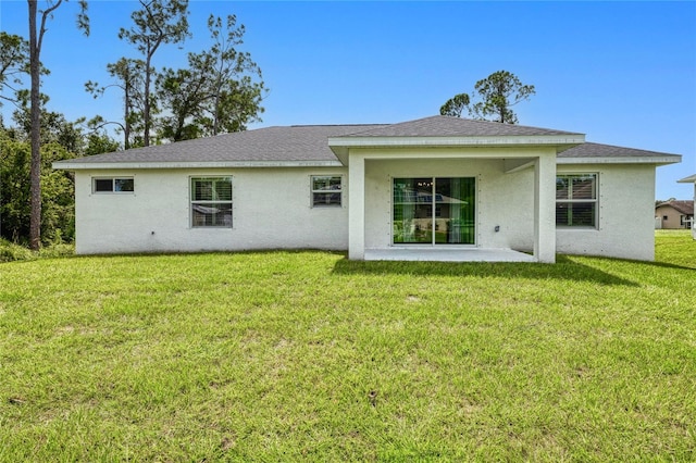 back of house featuring a lawn and a patio