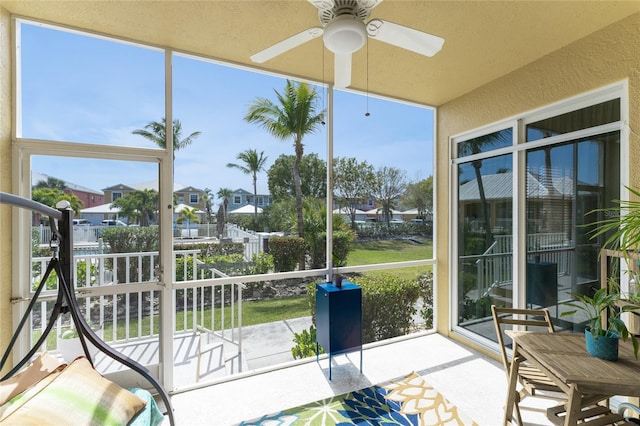 sunroom / solarium featuring ceiling fan