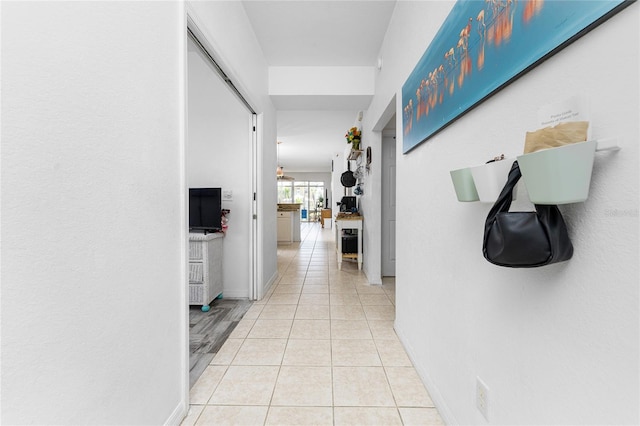 hall featuring light tile patterned flooring