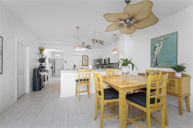 tiled dining space with ceiling fan