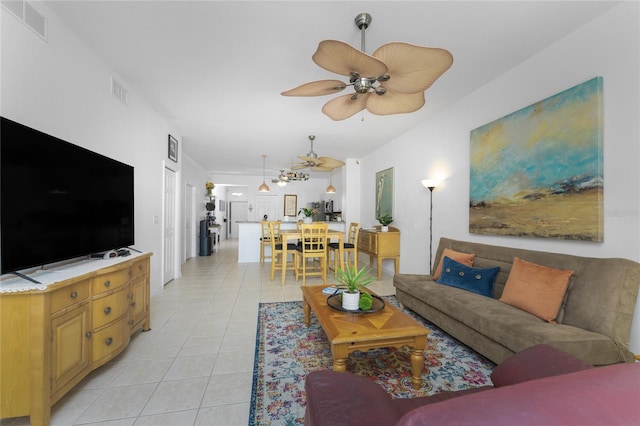 living room featuring ceiling fan and light tile patterned flooring