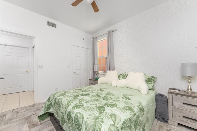 bedroom featuring ceiling fan and light parquet flooring