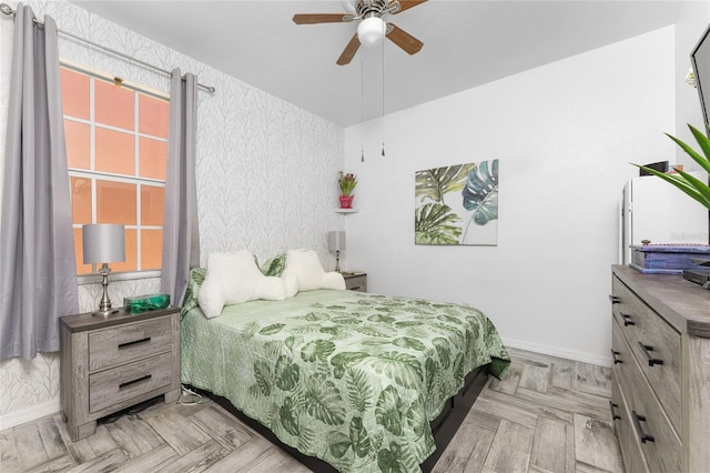 bedroom featuring ceiling fan and light parquet floors