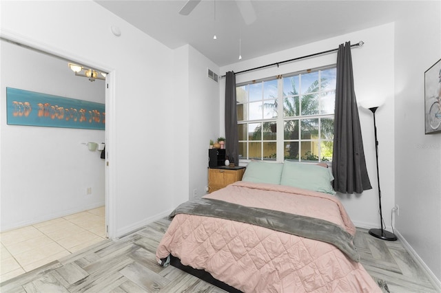 bedroom with ceiling fan and light parquet flooring