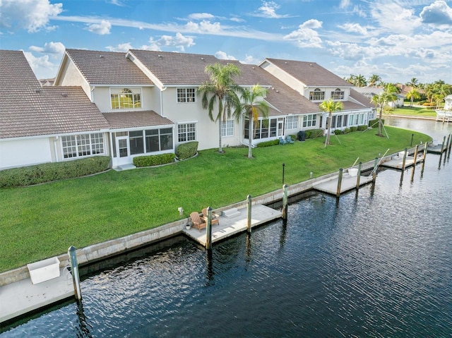 view of dock featuring a lawn and a water view