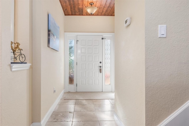 tiled entryway featuring wood ceiling