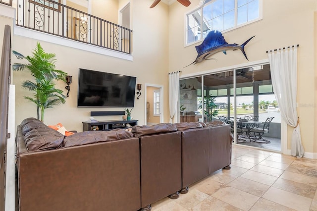 living room featuring a towering ceiling and ceiling fan