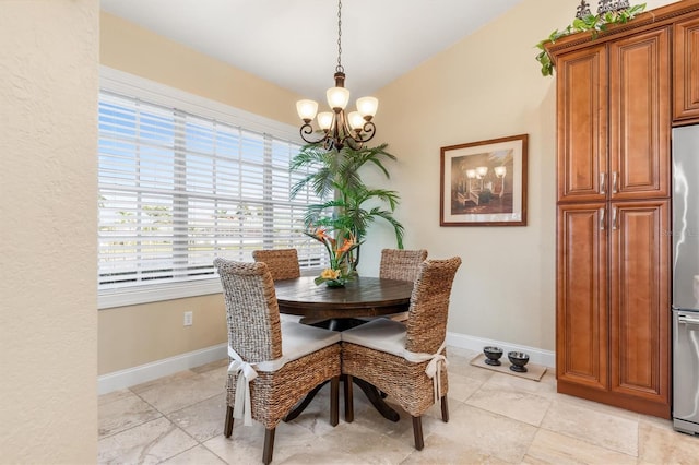 dining area featuring a notable chandelier